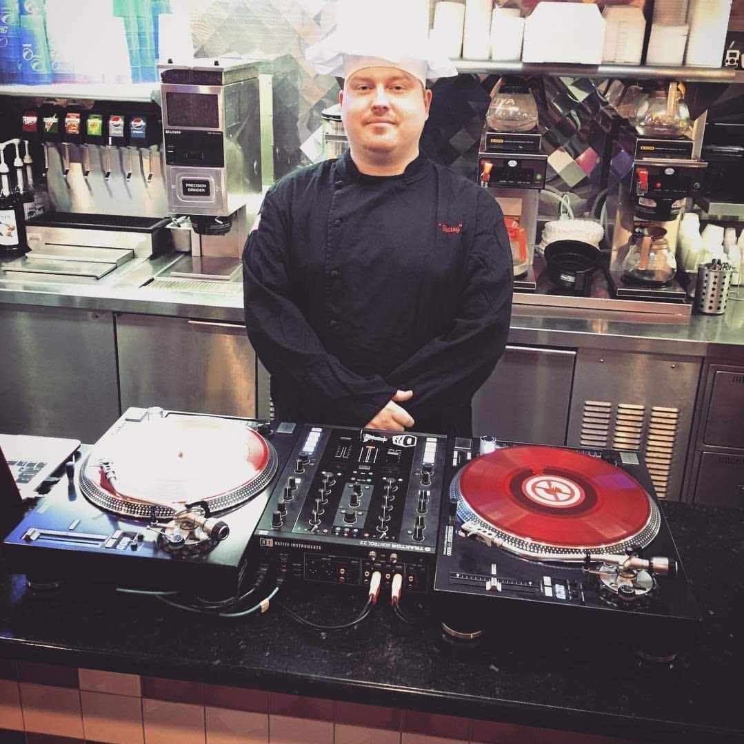 DJ Robzilla behind a pair of turntables on a music video shoot