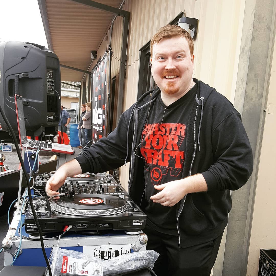 DJ Robzilla at the turntables, wearing a "Master Your Craft" hoodie